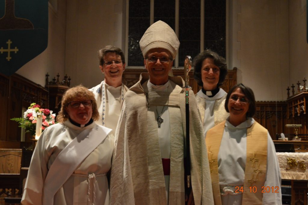 Diane surrounded by the bishop and her colleagues at St. Peter's